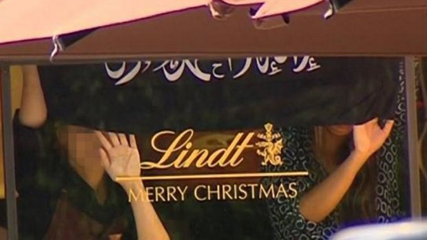 Hostages were earlier seen holding an Islamic flag that is not the Islamic State flag against the window of the Lindt Chocolat Cafe in Martin Place.