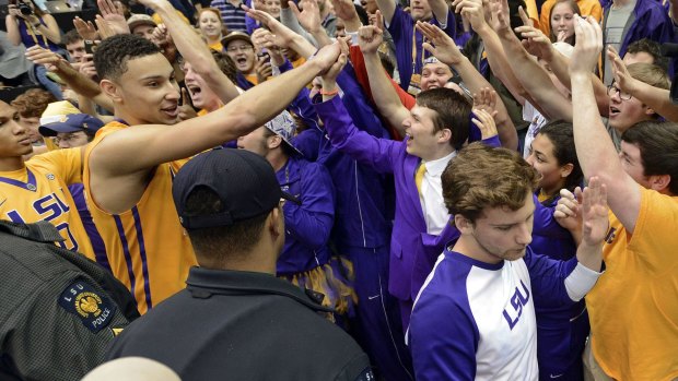 LSU forward Ben Simmons celebrates with fans after the win.