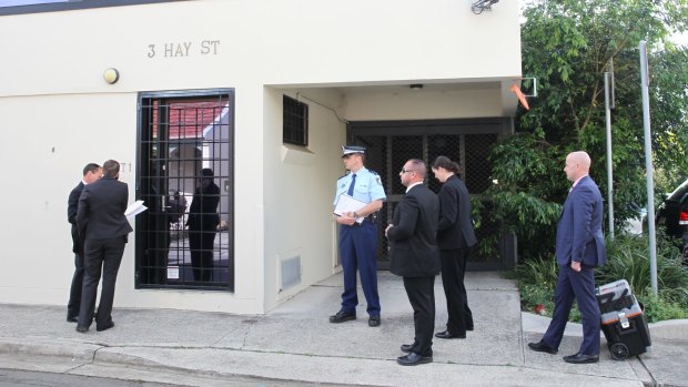 Police waiting to enter Sam Ayoub's office in Sydney. 