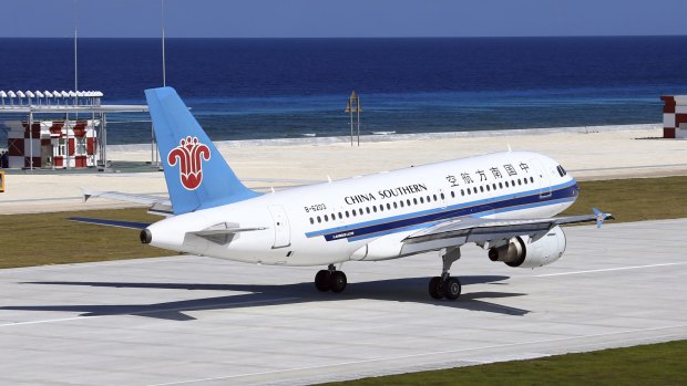 A China Southern Airlines jetliner lands at the airfield on Fiery Cross Reef, known as Yongshu Reef in Chinese, in the Spratly Islands.