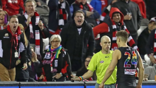 Feeling the heat: Footy fans make their feelings known - all within earshot of the umpires.