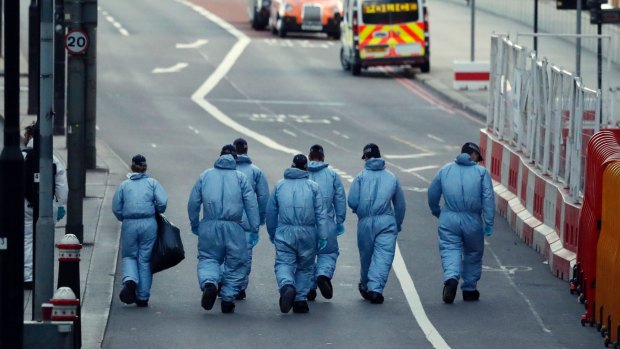 Forensic police collect evidence in the London Bridge area of London.