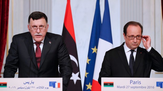 French President Francois Hollande, right, and Libya's Prime Minister Fayez al-Sarraj.