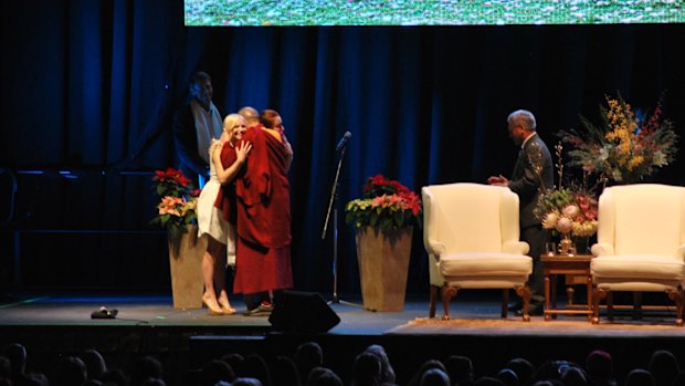 The religious leader embraced Wicked stars Suzie Mathers and Jemma Rix after a rendition of Happy Birthday.