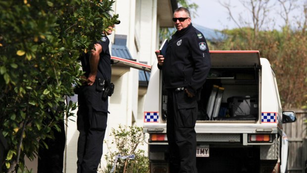 Police at the Bulimba townhouse after the woman was found.