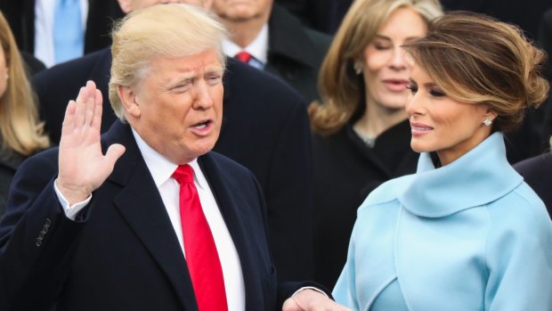 Donald Trump, watched by his wife Melania, is sworn in as the 45th president of the United States.