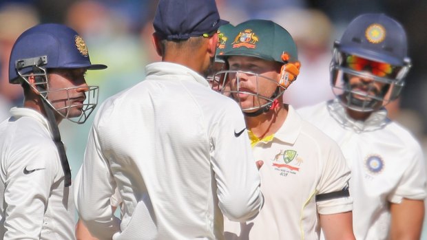 David Warner and Virat Kohli face up after the Australian exchanged words with Varun Aaron after being bowled on a no ball. 