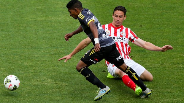 Archibald, right, playing for Melbourne City in 2014, tackling Roy Krishna. 