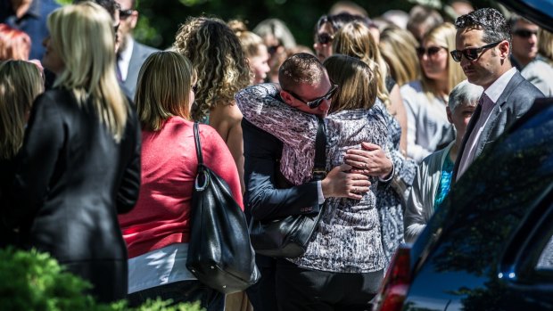 David Turner, partner of Kate Goodchild being comforted outside the funeral of siblings Kate Goodchild and Luke Dorsett.