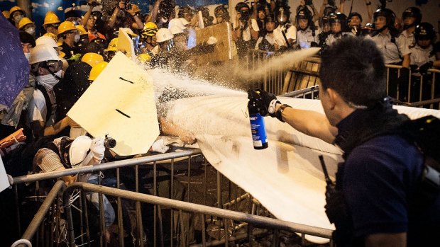 Determined actions: Pro-democracy protesters clash with police outside Hong Kong's government complex.