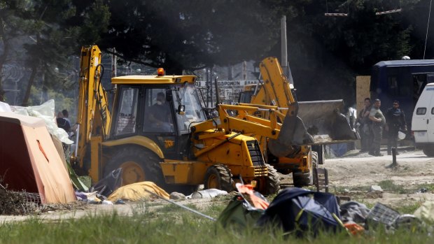 A bulldozer clears the makeshift refugee camp during a police operation at the Greek-Macedonian border near the northern Greek village of Idomeni on Tuesday. 