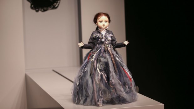 A miniature mannequin jerkily traverses the runway at the NGV.