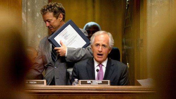 US Republican Presidential candidate and Senate foreign relations committee member, Senator Rand Paul, left, passes Committee Chairman Senator Bob Corker after the committee reached a compromise Tuesday.