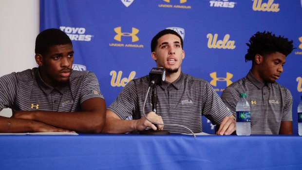 Flanked by teammates Cody Riley, left, and Jalen Hill, UCLA basketball player LiAngelo Ball reads his statement during a news conference at UCLA Wednesday on November 15 in Los Angeles.
