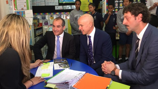 Victorian Education Minister James Merlino and NSW Education Minister Adrian Piccoli are taken on a tour of Footscray North Primary School. 