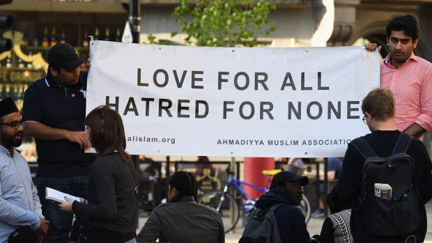 Members of the Muslim community attend a candlelit vigil, to honour the victims of Monday evening's terror attack, at Albert Square in Manchester.