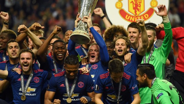 Wayne Rooney hoists the Europa League trophy for Manchester United on May 24.