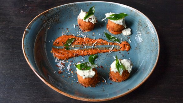 Sambar arancini with tempered coconut and a swipe of tomato relish.