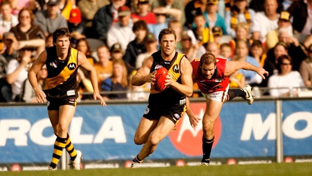 Joel Bowden outruns Mark Ricciuto during the Richmond Tigers match against Adelaide Crows at Telstra Dome. Photographed May 20, 2006, by John Donegan for Sunday Sport.