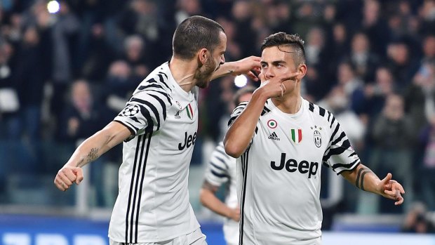 Juventus' Paulo Dybala, right, celebrates with teammate Leonardo Bonucci.