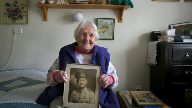 Mrs Doris Johnson, 91, with a photo of her late husband Neville Johnson.