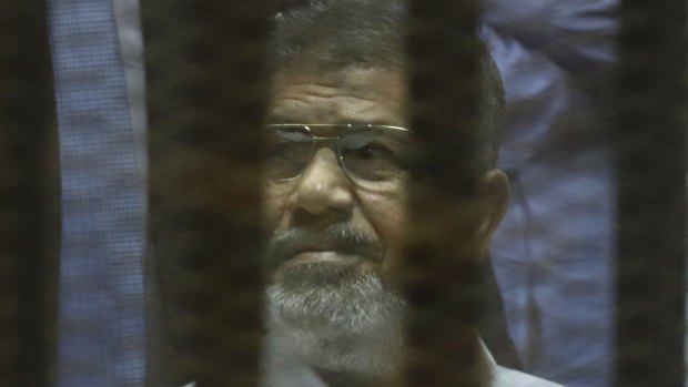 Egypt's ousted president Mohamed Morsi  in a soundproof glass cage at Egypt's national police academy in Cairo on Tuesday.