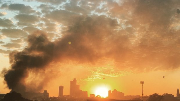 The sunrise in Melbourne and smoke from the South Melbourne fire at The Albion rooftop.