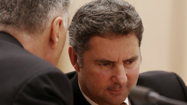 Larry Marshall, right, chief executive of CSIRO, confers with deputy Craig Roy at the Senate committee hearing.