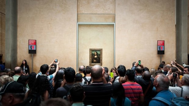 Crowds surround the Louvre's most famous exhibit.