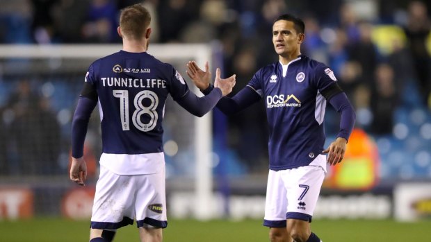 Lion's den: Millwall's Ryan Tunnicliffe (left) and Tim Cahill shake hands after the final whistle.