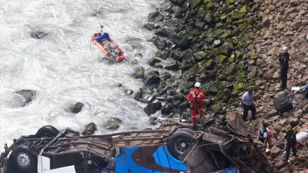 An injured man being transported over water. The bus was carrying 57 passengers, a driver and a crew member.