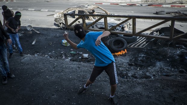 A Palestinian protester clashes with Israeli border police on October 9 in Jerusalem. Palestinians' frustration with Israel has again come to the boil.