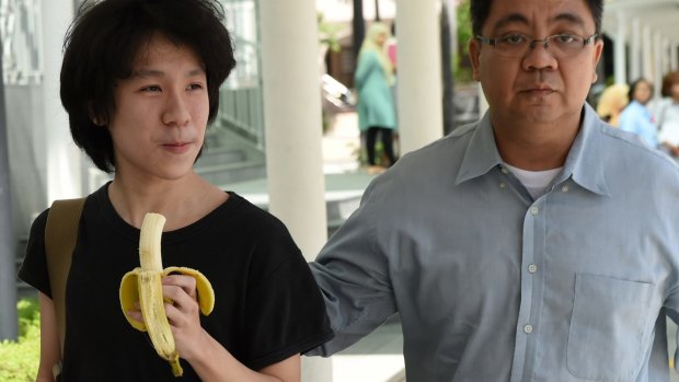 Amos Yee walking with his father to the state courts in Singapore. 
