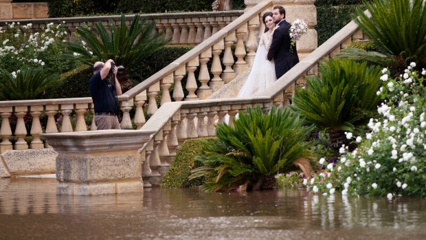 The lucky couple didn't let the flooding affect their wedding photos.