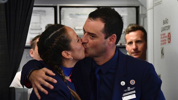 Crew members Paula Podest and Carlos Ciufffardi kiss before journalists after being married by Pope Francis during the flight between Santiago and the northern city of Iquique, in Chile.
