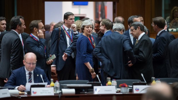Theresa May, UK prime minister, centre, looks on ahead of roundtable talks with European Union (EU) leaders in Brussels.