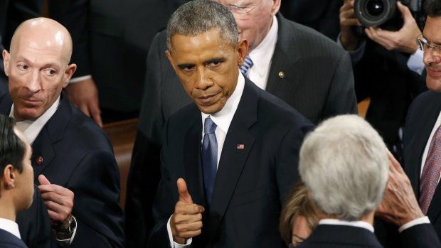 US President Barack Obama gives a thumbs up to Secretary of State John Kerry.