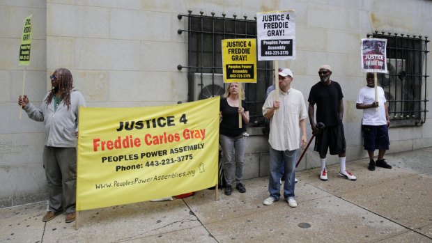 Demonstrators outside a courthouse await a verdict in the trial of officer Caesar Goodson.