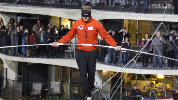 Death-defying: Nik Wallenda tackles the tightrope as a crowd looks on. 