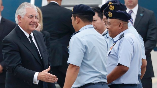 US Secretary of State Rex Tillerson, left, is greeted by Malaysian Air Force officials at a military base in Subang.