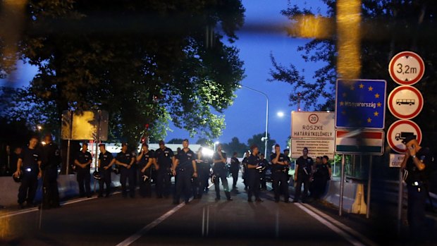 Hungarian police officers guard the border crossing "Horgos 2" into the Hungary.