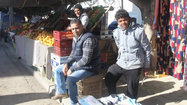 Hmaidia Mohjoub, 34, centre, lost his job because of the revolution and was also unable to find work in Tunis.