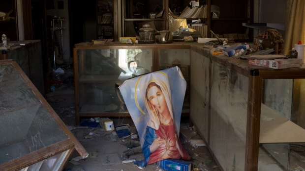 An image of the Virgin Mary is seen placed at a destroyed church in the newly liberated town of Bartella in Gogjali, Iraq.