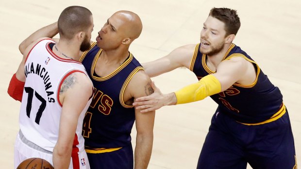 In your face: Jonas Valanciunas of the Raptors and Richard Jefferson of the Cleveland Cavaliers exchange words.