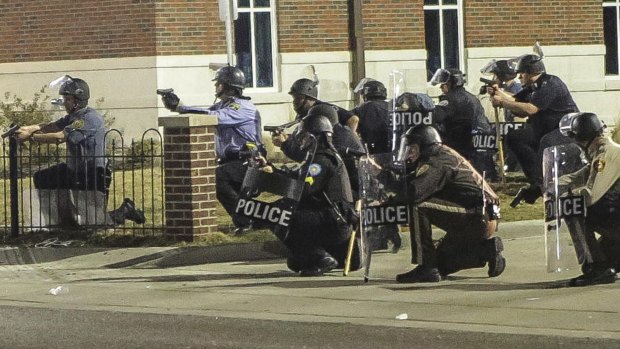 Police officers respond after shots were fired outside outside Ferguson Police Headquarters on Thursday.