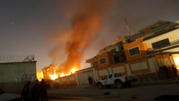 Flames rise from the foreign aid workers' guesthouse after Saturday's attack in Kabul.
