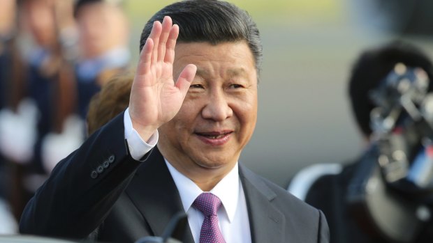 China's President Xi Jinping waves after arriving in Germany for the G20 summit. 