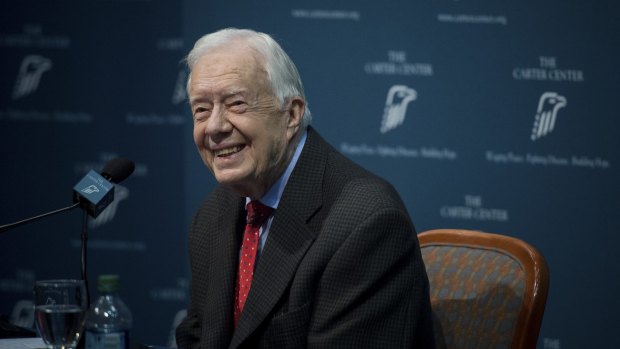 At peace ... former US president Jimmy Carter smiles during his press conference.