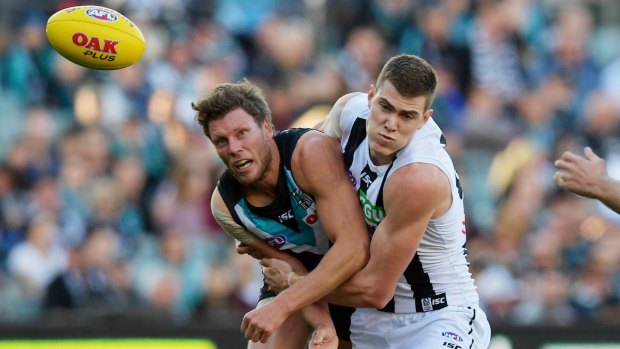 Sacked: Magpie Mason Cox wraps up Power's Brad Ebert in a tackle.