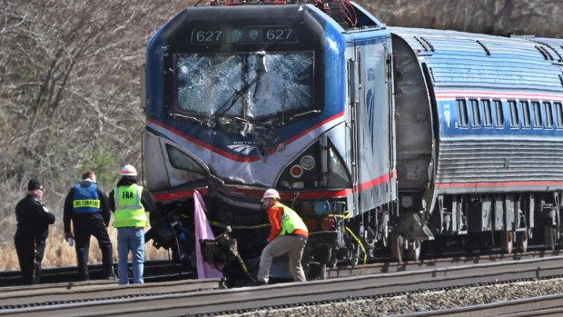 Amtrak investigators inspect the damaged train in Chester, Pennsylvania.